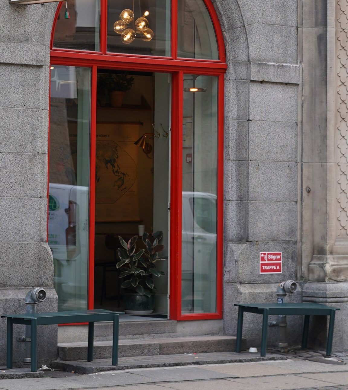 Red-framed arched doorway of a SHOUT Media coffee shop entrance